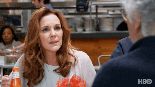 elizabeth perkins eating something with a lot of ketchup on it in curb your enthusiasm