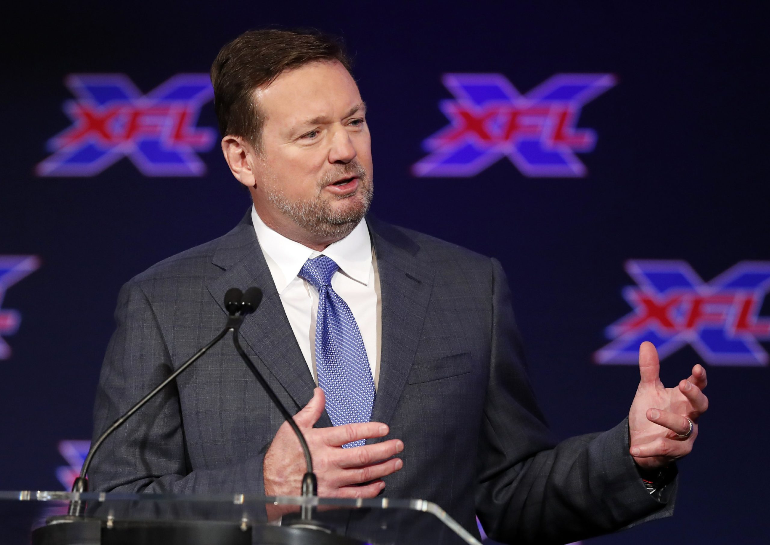 coach bob stoops speaking at a press conference for the xfl